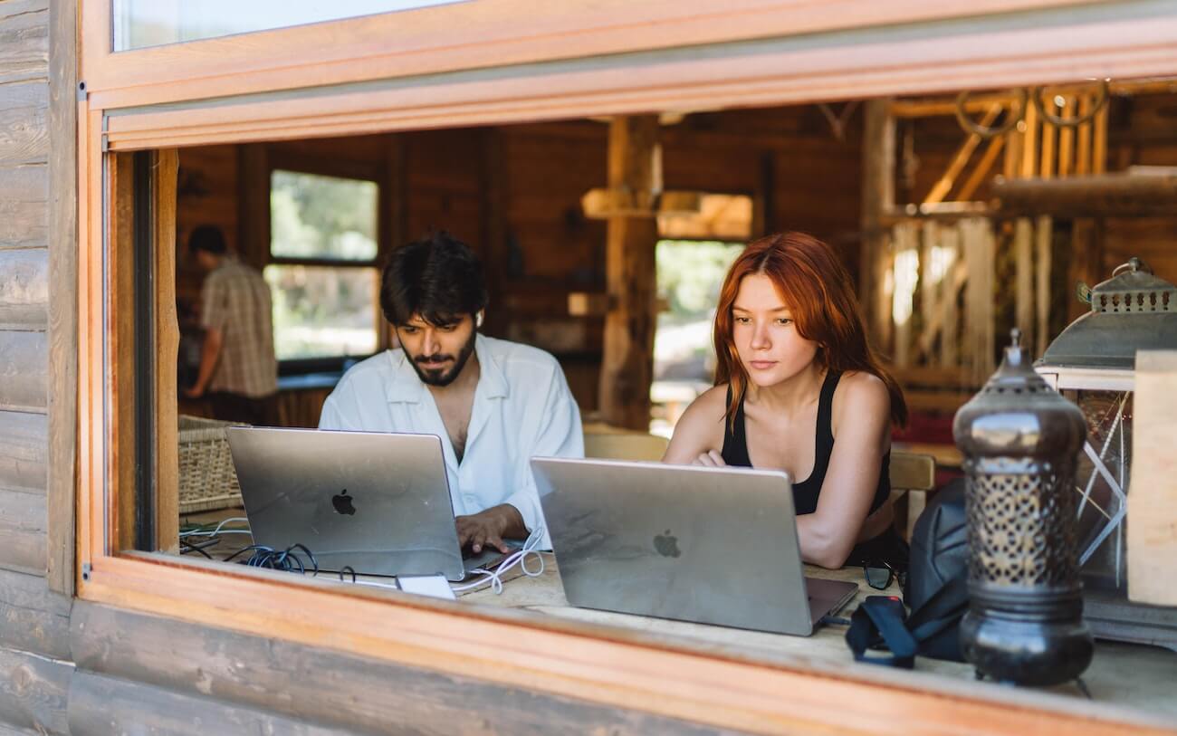 Two students preparing on laptops