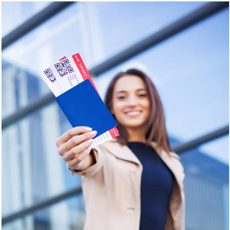 Traveller holding up a passport and air tickets